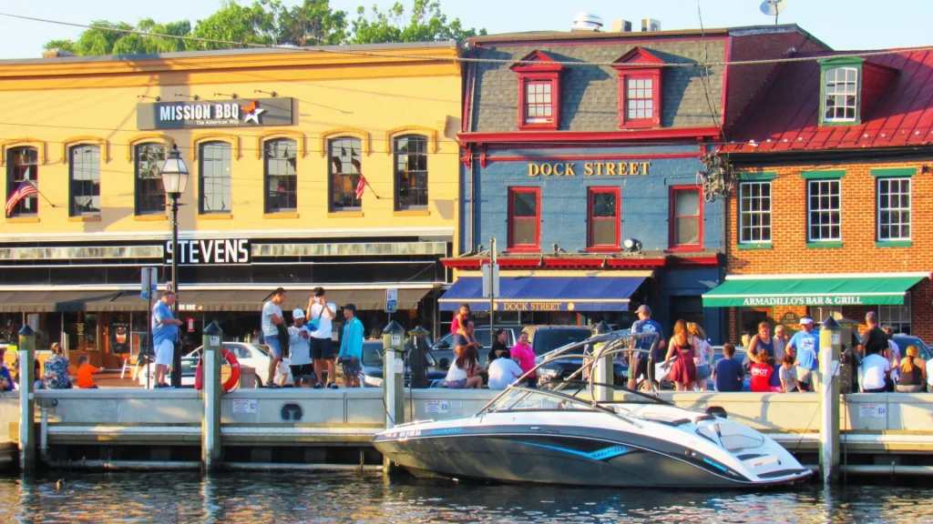 a boat is docked in front of a row of colorful buildings