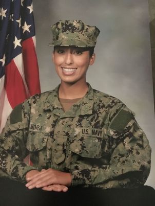 Gaby posed with her arms crossed in her US Navy uniform