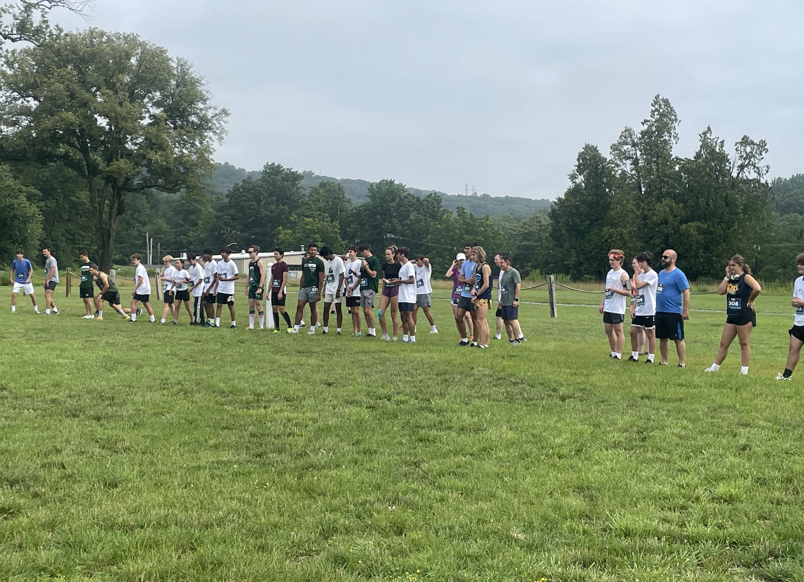 Participants of the first annual Jania Mania Race for Veteran Charities are lined up in a green field with trees in the background